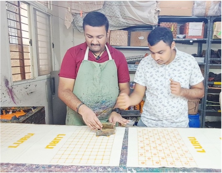 Trainees block printing on fabric at Nav Prabhuti